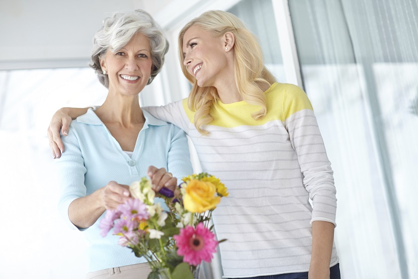 Portrait of a senior woman enjoying some flower arranging with her daughter